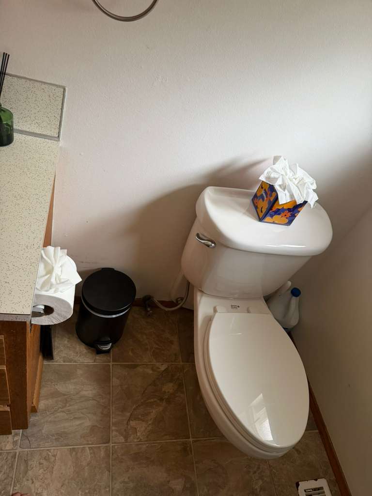 Sanitized toilet and clean tile floor after a bathroom cleaning
