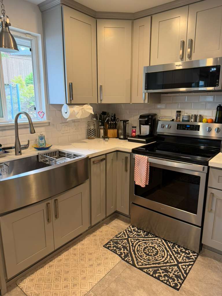 Spotless kitchen sink and stove in a Seattle home after house cleaning