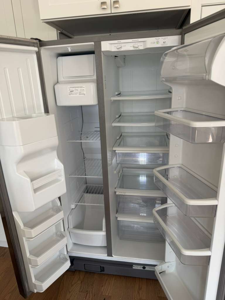 Refrigerator interior cleaned shelf by shelf during a deep cleaning